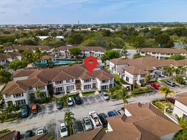 an aerial view of multiple houses with a city