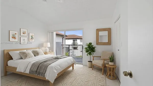 a bedroom with a bed and a couch