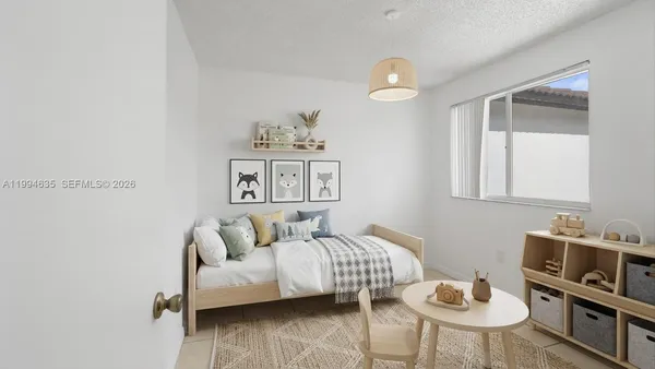 a bedroom with furniture and a window