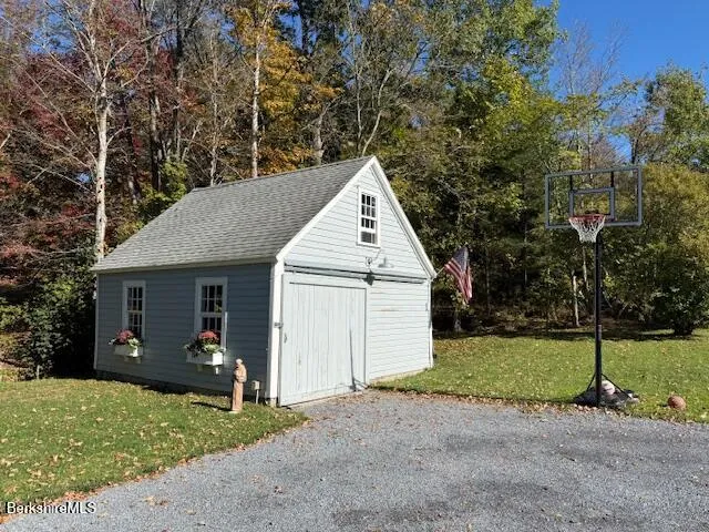 a view of a house with a yard and garage