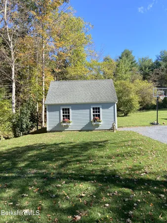 a aerial view of a house next to a big yard