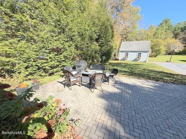 a view of a patio with table and chairs and potted plants