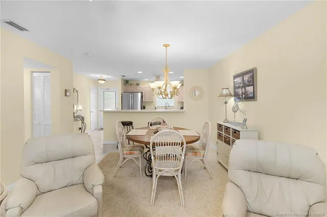 a dining room with furniture and a chandelier