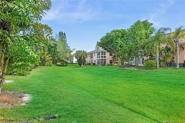 a view of house with garden space and trees