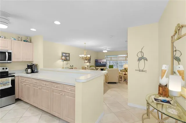 a kitchen with white cabinets and sink
