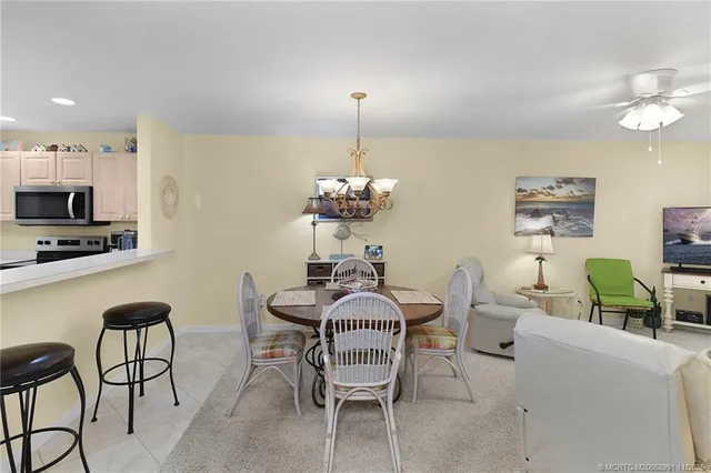 a dining room with furniture and chandelier