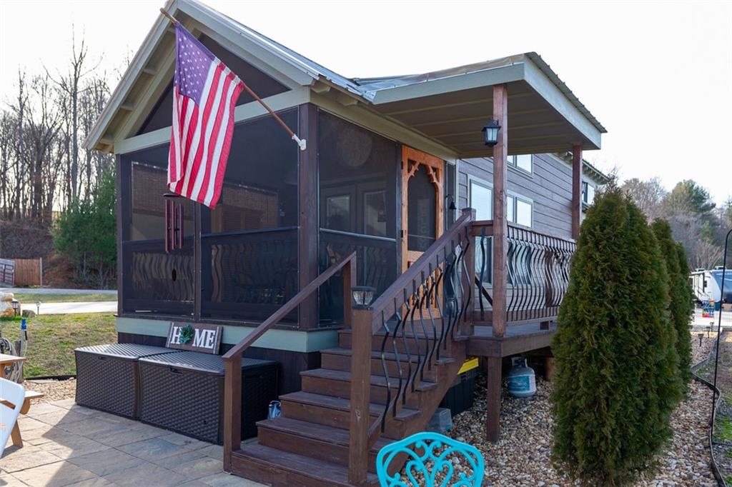 a front view of house with deck and outdoor seating
