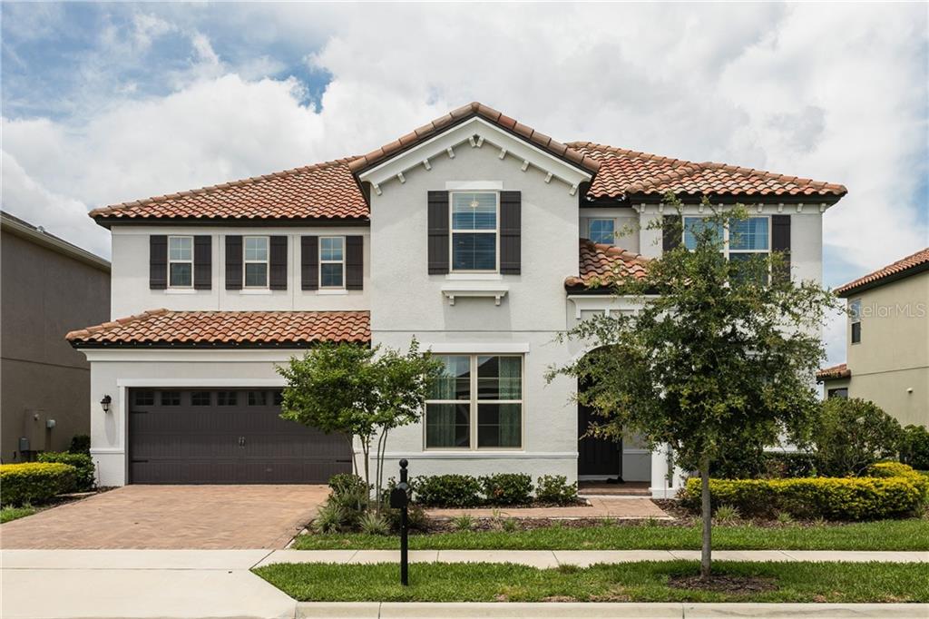 14118 Magnolia Ridge Loop Winter Garden, FL 34787 - Photo 1 of 1 a front view of a house with a yard