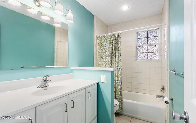 a bathroom with a sink a toilet and a large mirror