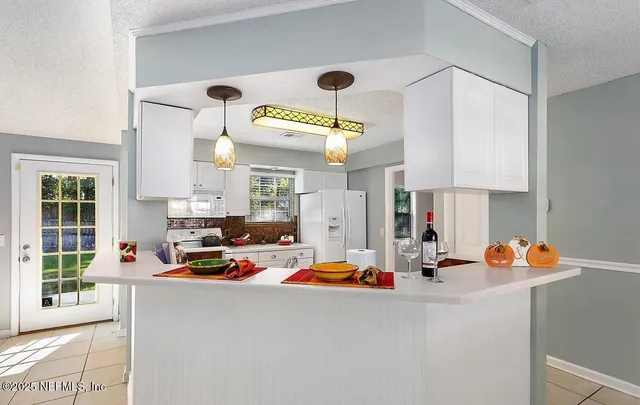 a kitchen with counter top space appliances and cabinets