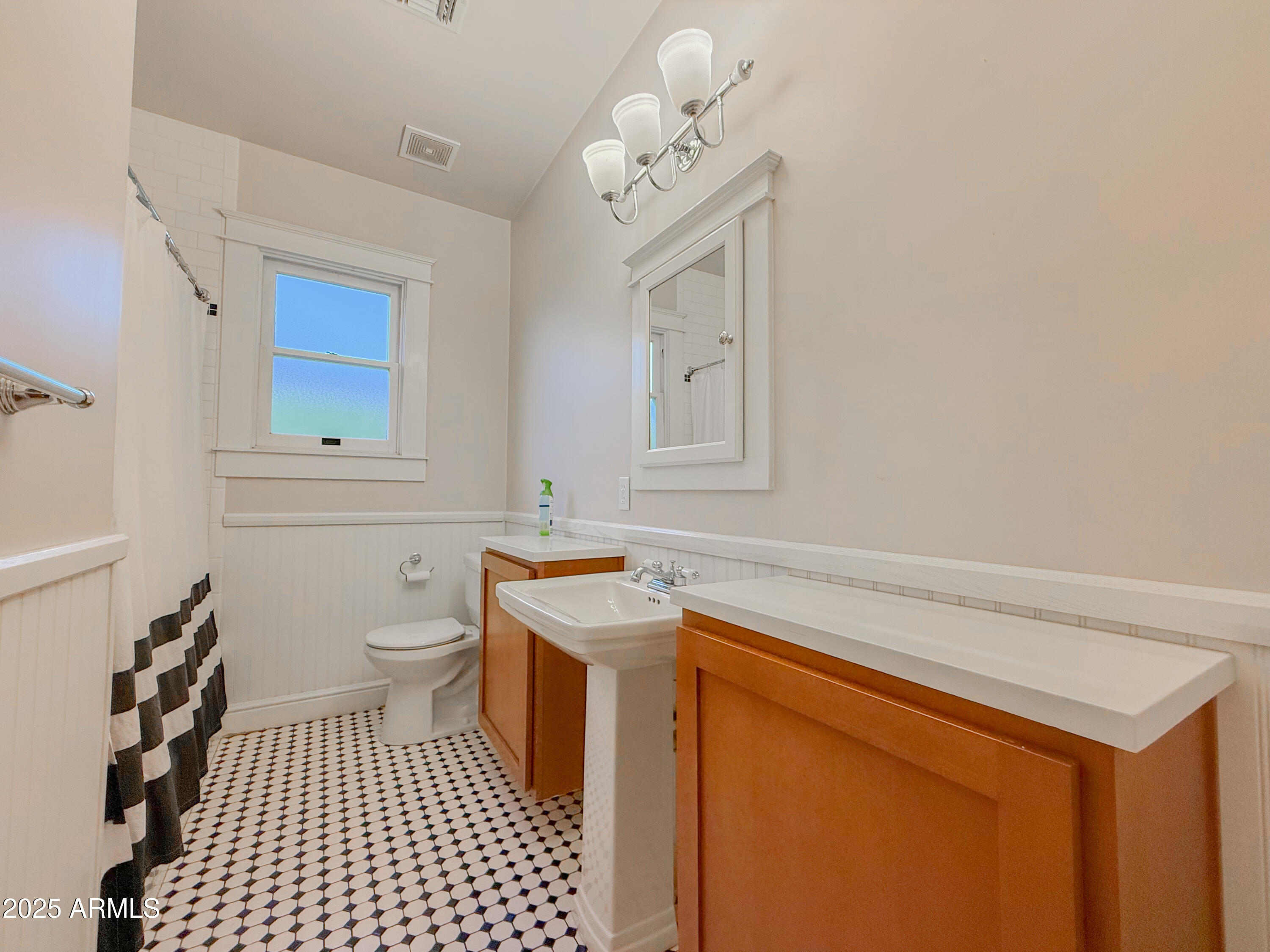 56 East Vernon Avenue Phoenix, AZ 85004 - Photo 11 of 29 a bathroom with a sink a toilet and a mirror