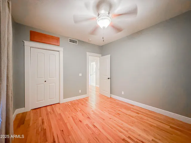 a view of an empty room and wooden floor