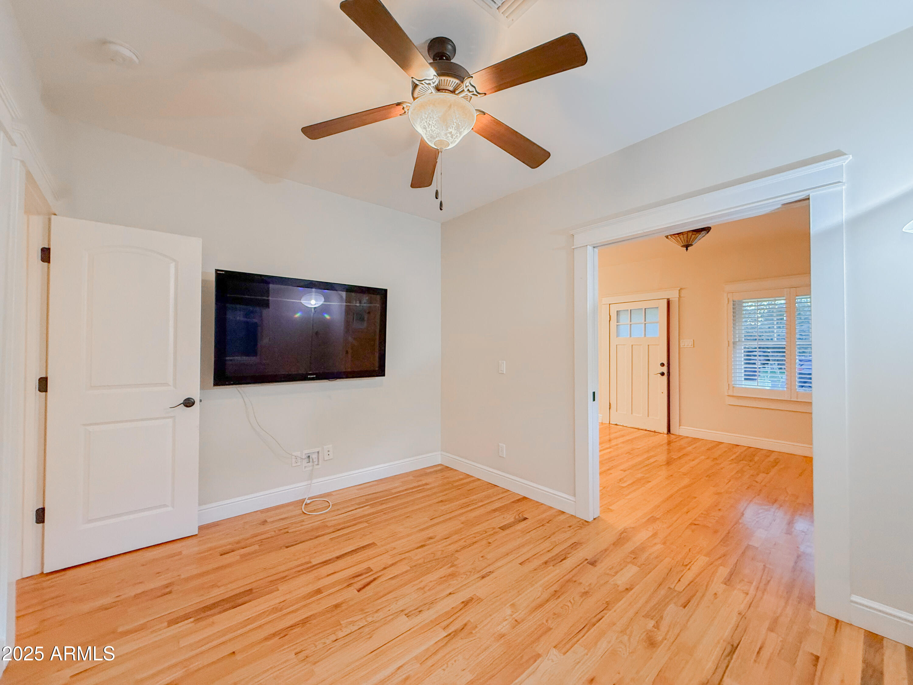 56 East Vernon Avenue Phoenix, AZ 85004 - Photo 21 of 29 a view of empty room with wooden floor and fan