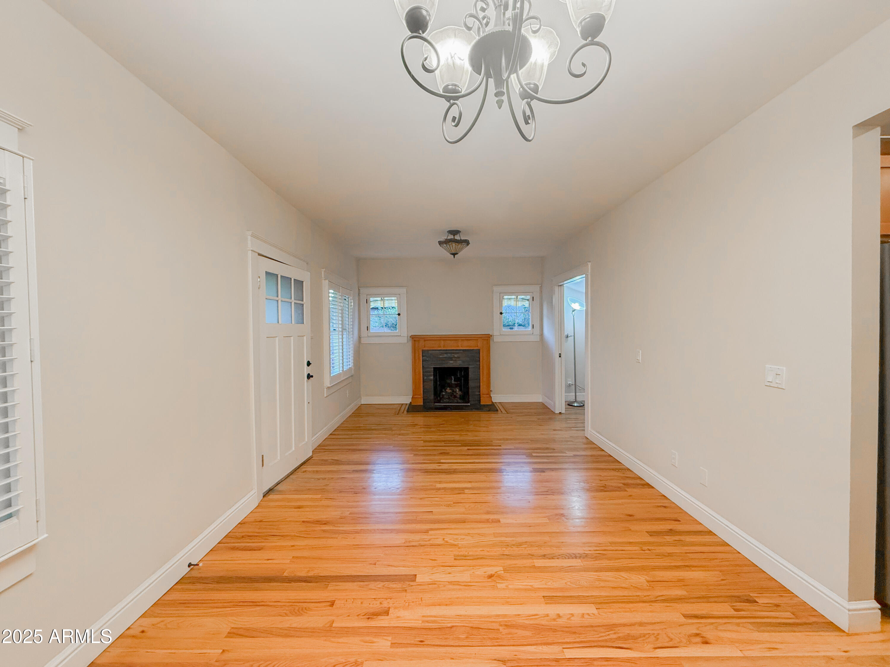 56 East Vernon Avenue Phoenix, AZ 85004 - Photo 6 of 29 a view of an empty room with wooden floor and fireplace