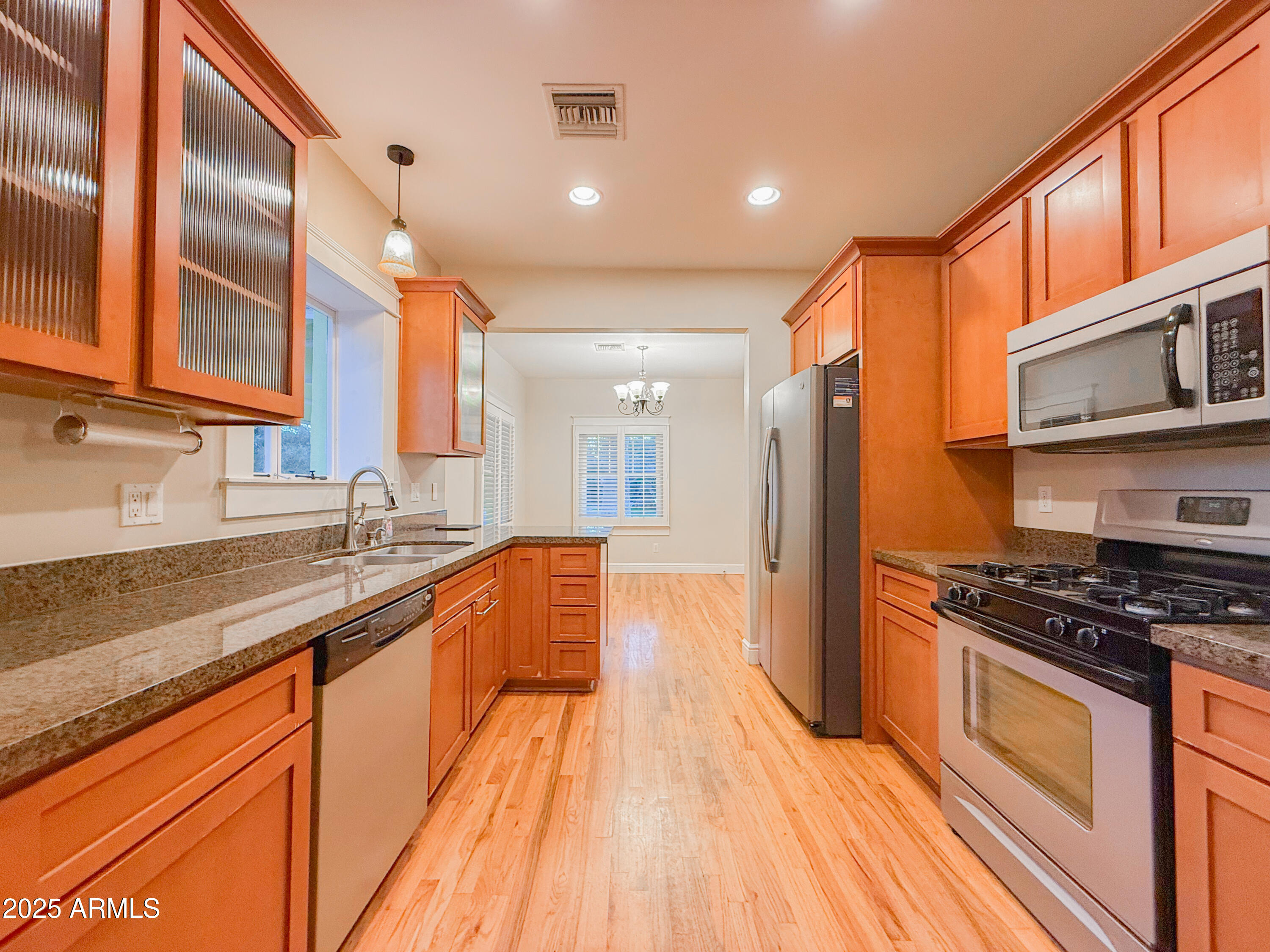 56 East Vernon Avenue Phoenix, AZ 85004 - Photo 9 of 29 a kitchen with stainless steel appliances granite countertop a stove and a sink