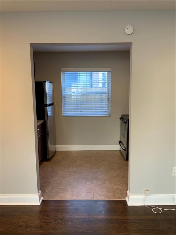 805 Piedmont Avenue Northeast, Unit 5 Atlanta, GA 30308 - Photo 4 of 12 a view of empty room with wooden floor and closet