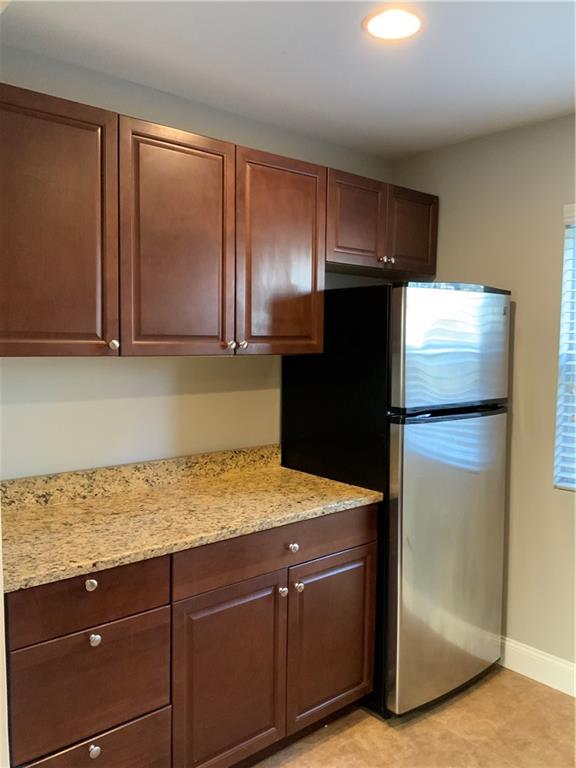 805 Piedmont Avenue Northeast, Unit 5 Atlanta, GA 30308 - Photo 5 of 12 a kitchen with a refrigerator and cabinets
