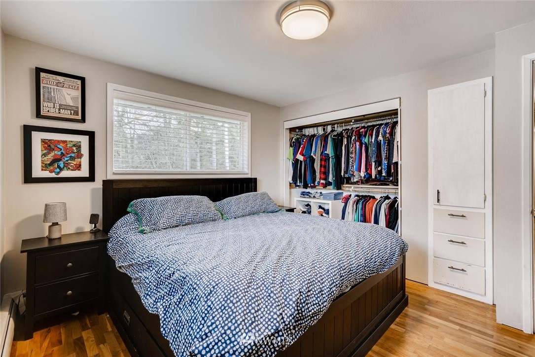 17810 98th Avenue South Renton, WA 98055 - Photo 11 of 28 a bedroom with a bed a dresser and a book shelf
