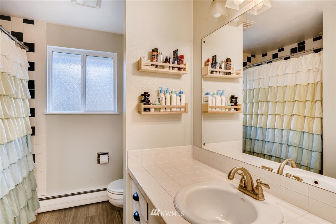 17810 98th Avenue South Renton, WA 98055 - Photo 13 of 28 a bathroom with a sink and a mirror