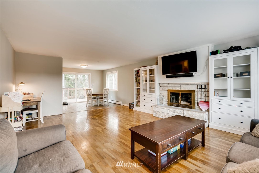 17810 98th Avenue South Renton, WA 98055 - Photo 3 of 28 a living room with furniture a flat screen tv and a fireplace