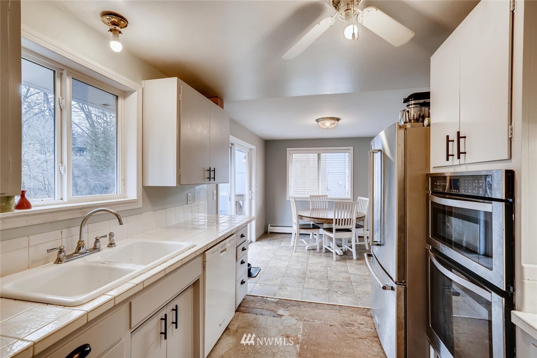 17810 98th Avenue South Renton, WA 98055 - Photo 9 of 28 a kitchen with sink refrigerator and cabinets