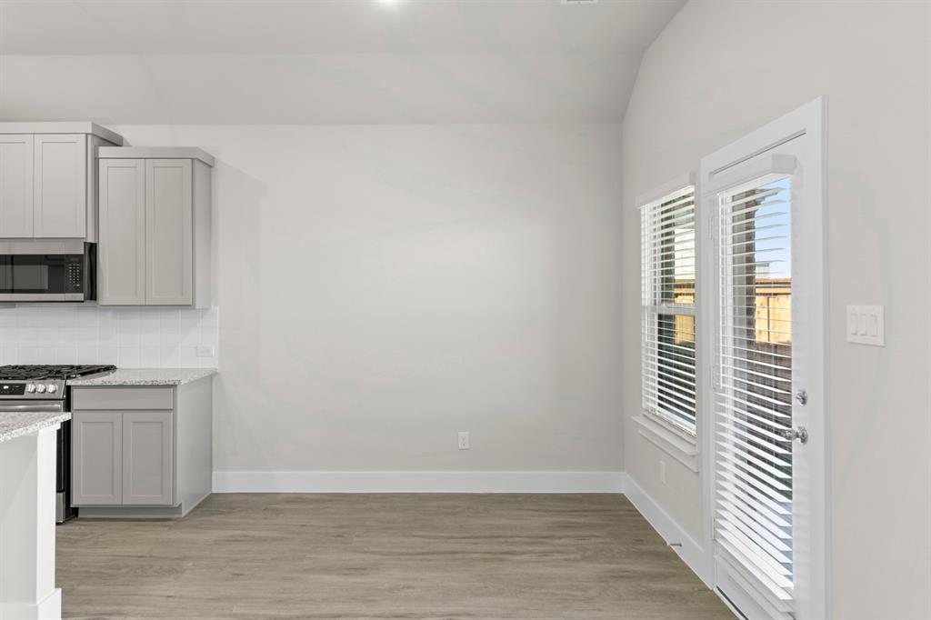2372 Bell Way Forney, TX 75126 - Photo 2 of 39 a view of a kitchen with wooden floor and a window