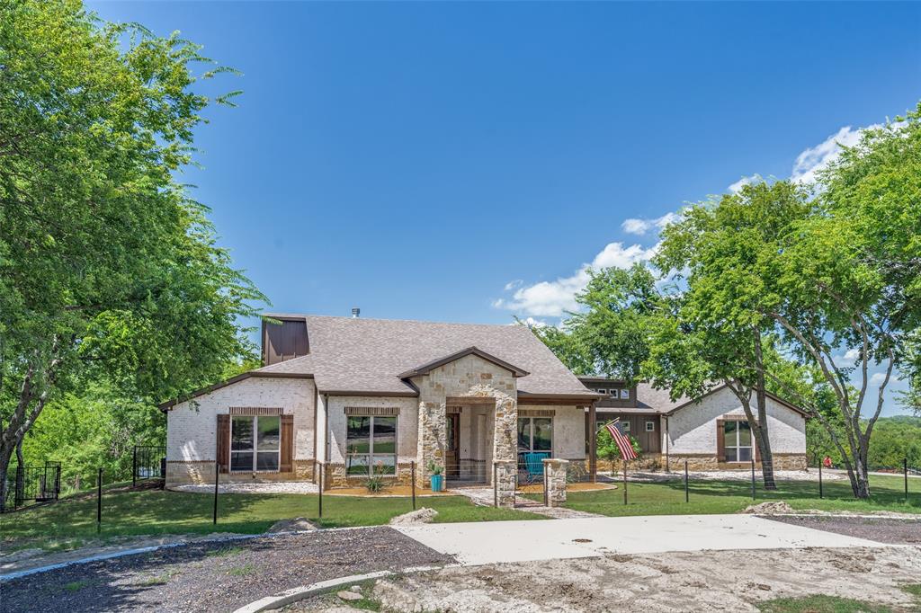 626 Lone Tree Road Nevada, TX 75173 - Photo 2 of 40 a front view of a house with a garden and trees