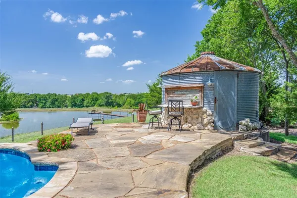 a view of a house with backyard porch and sitting area