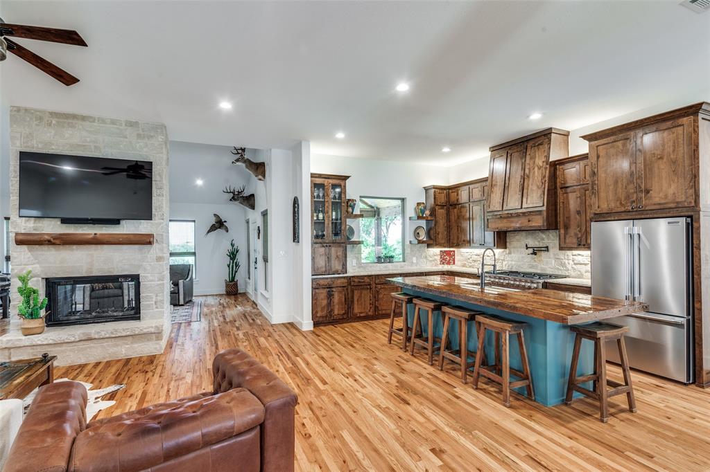 626 Lone Tree Road Nevada, TX 75173 - Photo 3 of 40 a living room with fireplace furniture and a flat screen tv