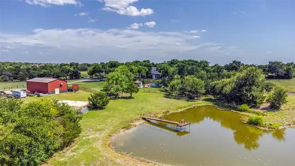 an aerial view of a house with swimming pool outdoor seating and yard