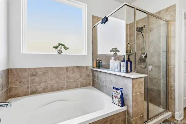 a bath tub sitting next to a bathroom sink