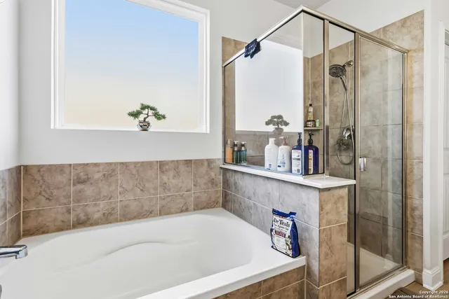 a bath tub sitting next to a bathroom sink