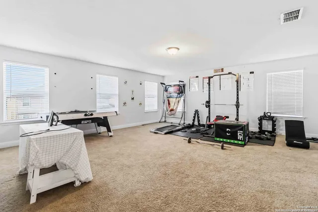 a view of a big room with gym equipment