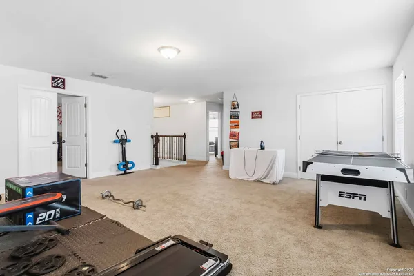 a bedroom with furniture and a book shelf