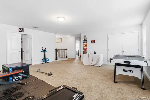 a bedroom with furniture and a book shelf