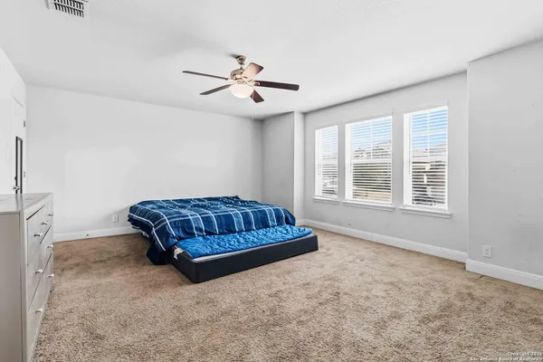 a living room with a bed furniture and a window