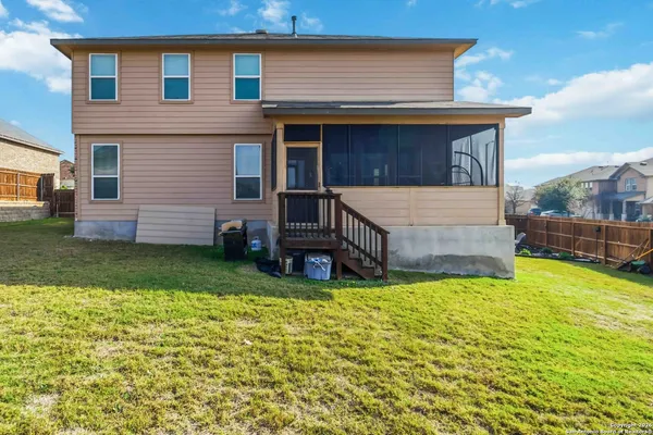 a view of a house with a yard and sitting area