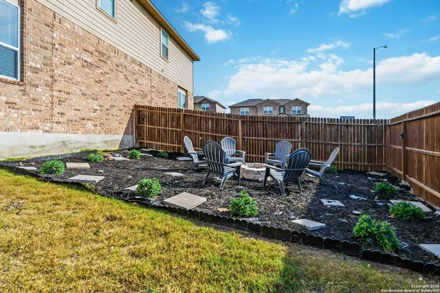 a view of a chair and tables in the patio
