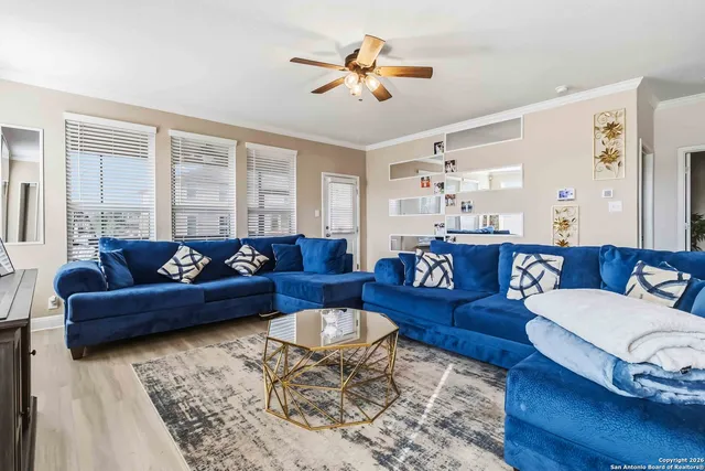 a living room with furniture ceiling fan and a rug