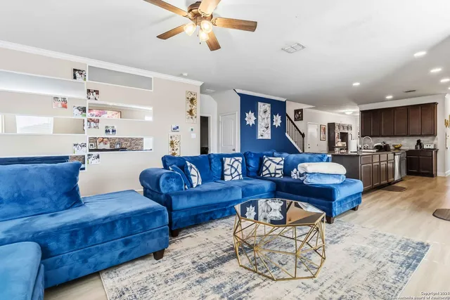 a living room with furniture and kitchen view