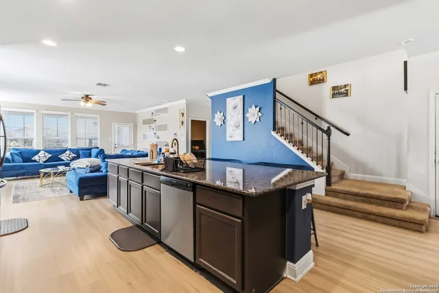 a kitchen with stainless steel appliances granite countertop a stove and a sink