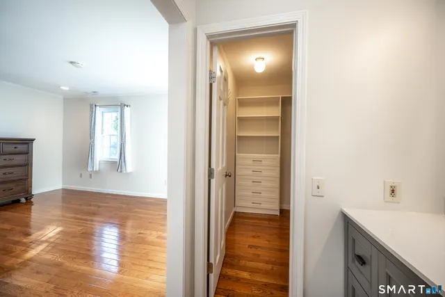 a view of a hallway with wooden floor
