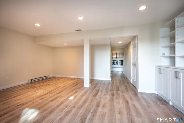 a view of an empty room and wooden floor