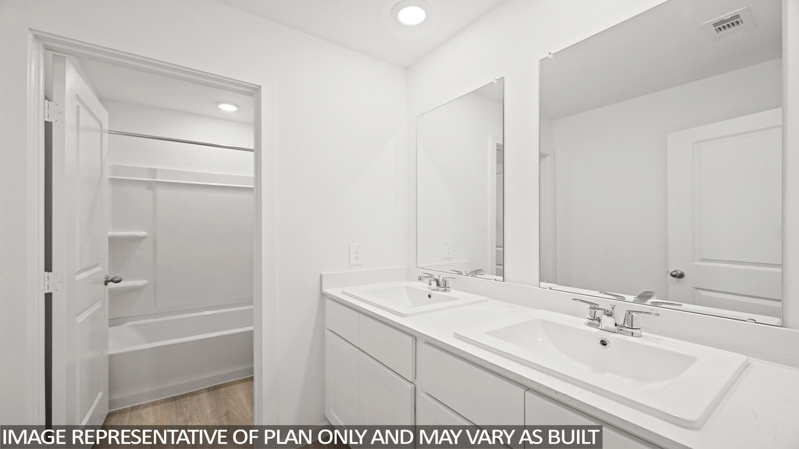 165 Baby Calf Roping Road Jarrell, TX 76537 - Photo 20 of 24 A well-lit bathroom offers a dual vanity with spacious counter space and a clean shower-tub combination.