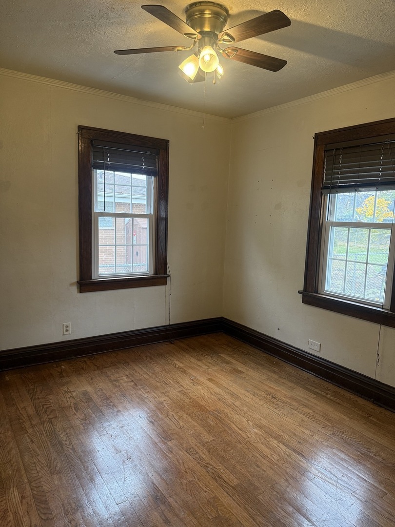 3035 Peoria Street Steger, IL 60475 - Photo 13 of 19 a view of an empty room with wooden floor and a window