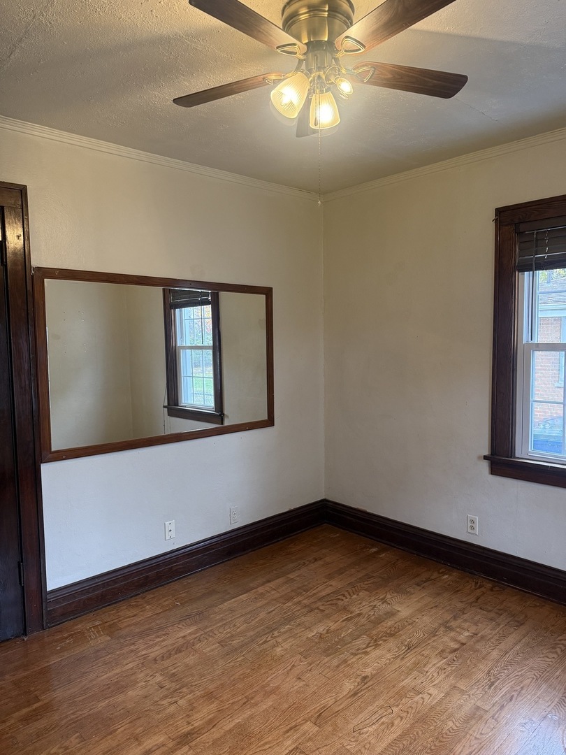 3035 Peoria Street Steger, IL 60475 - Photo 14 of 19 a view of an empty room with a window and wooden floor