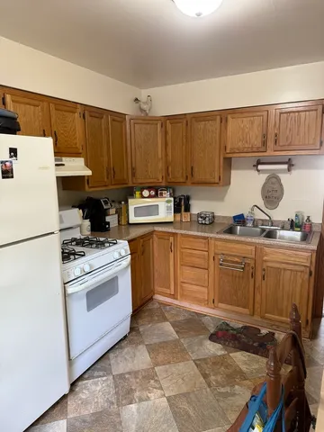 a kitchen with a refrigerator and a stove
