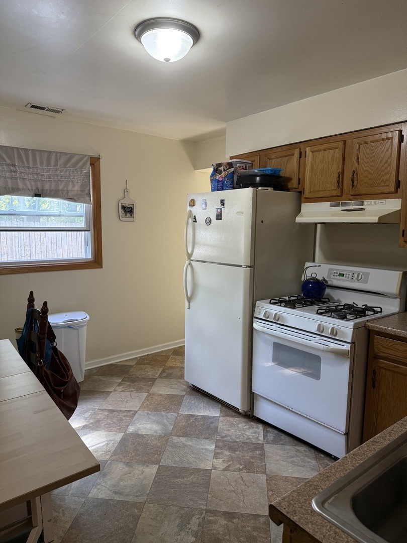 3035 Peoria Street Steger, IL 60475 - Photo 16 of 19 a kitchen with a refrigerator and a stove