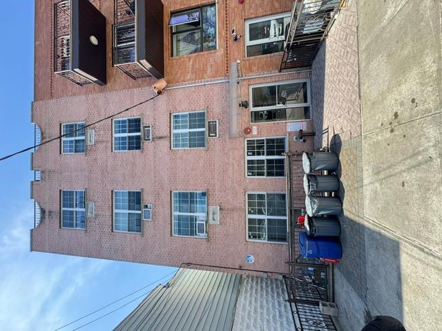 a view of a brick building and many windows