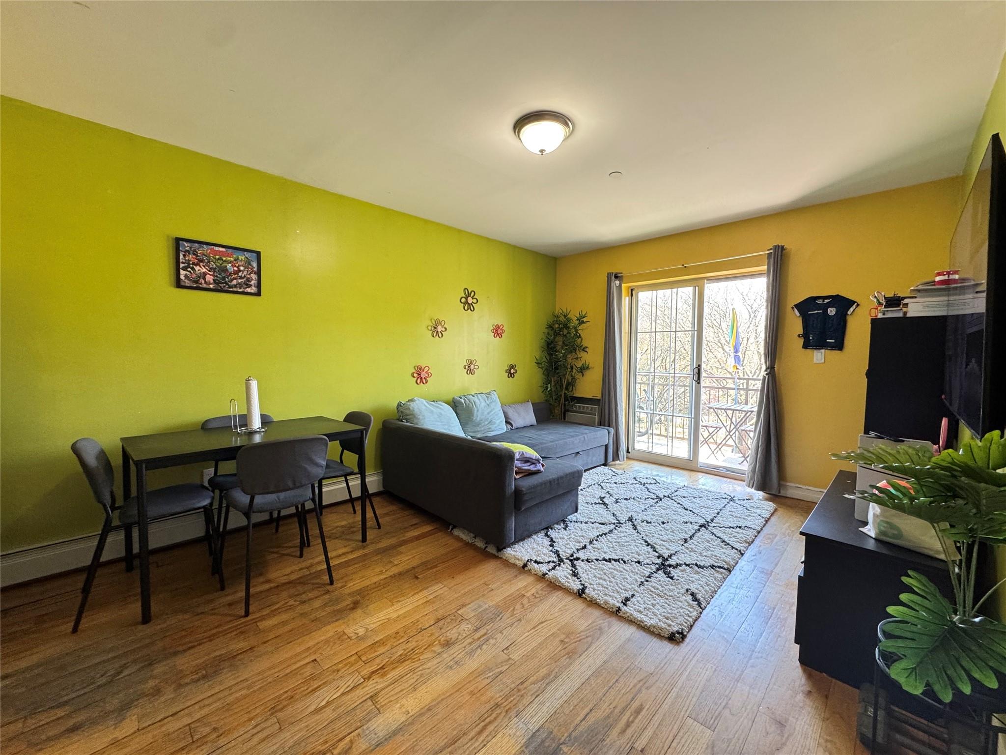 53-12 102nd Street Queens, NY 11368 - Photo 3 of 8 a living room with furniture and a table
